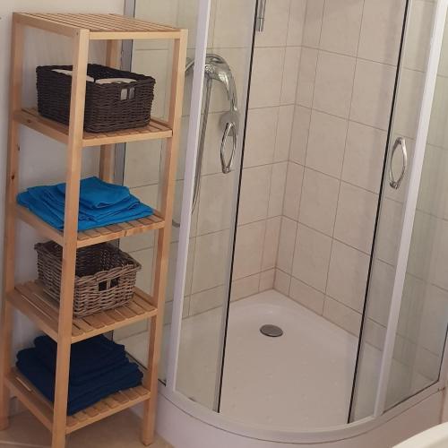 a shower in a bathroom with baskets and towels at Ferienwohnung Krahm in Nümbrecht