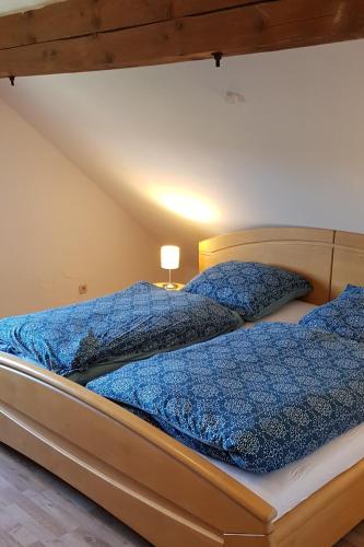 a bedroom with two beds with blue comforters at Ferienwohnung Krahm in Nümbrecht