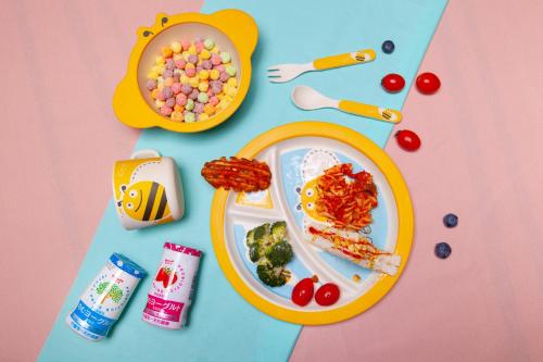a table topped with a plate of food and candy at Chao Motel in Taoyuan