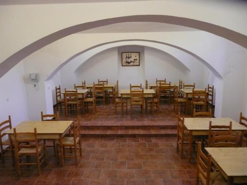 an empty dining room with wooden tables and chairs at Koleje Zamecek in Lednice