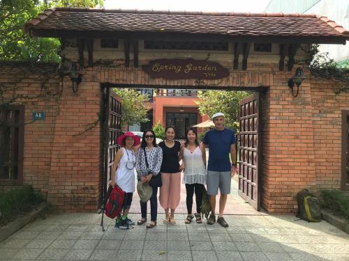 a group of people standing in front of a brick building at Spring Garden Villa in Hue