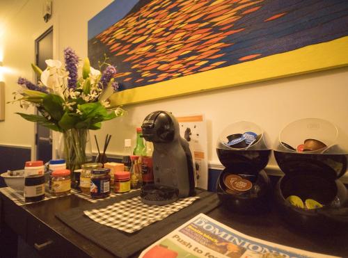 a kitchen counter with a vase of flowers and a mixer at U Residence Hotel in Wellington
