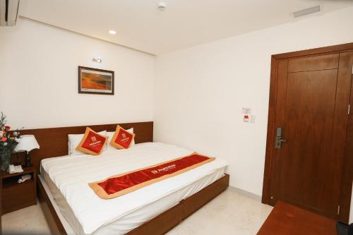 Postel nebo postele na pokoji v ubytování Hacom Galaxy Hotel