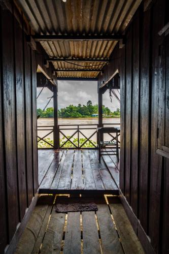a view from the inside of a wooden building at Mr Tho's Bungalows in Don Det