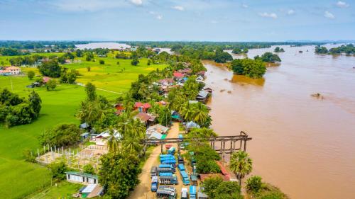 an aerial view of a town next to a river at Mr Tho's Bungalows in Don Det