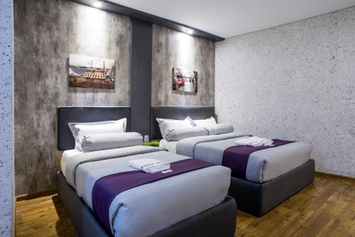 Postel nebo postele na pokoji v ubytování Axiaa Hotel