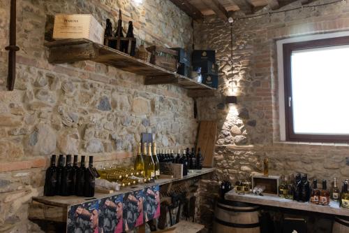 a bar with bottles of wine on a stone wall at Agriturismo La Ratta in Vernasca