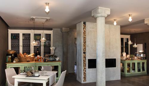 a dining room with a table and a column at Agriturismo La Ratta in Vernasca
