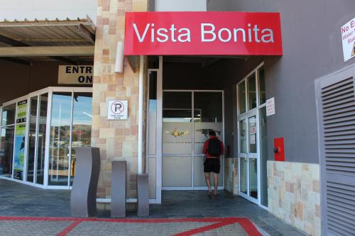 a person standing outside of a vista bombinia building at Vista Bonita Apartments in Mossel Bay