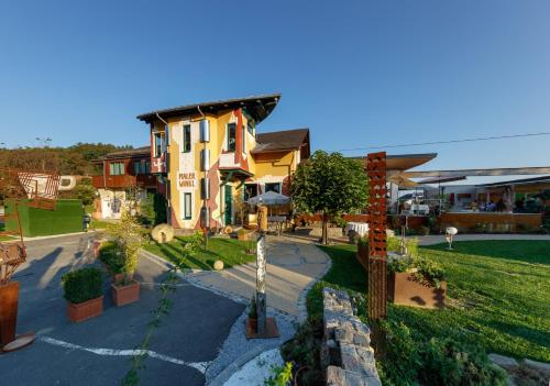 a large house with a garden in front of it at Malerwinkl Restaurant + Kunsthotel in Hatzendorf