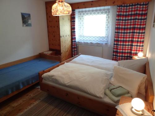 a bedroom with a bed and a window at Haus Eberhard in Vent