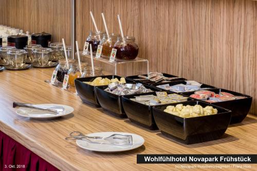 a buffet of food on a wooden table at NOVAPARK Flugzeughotel Graz in Graz