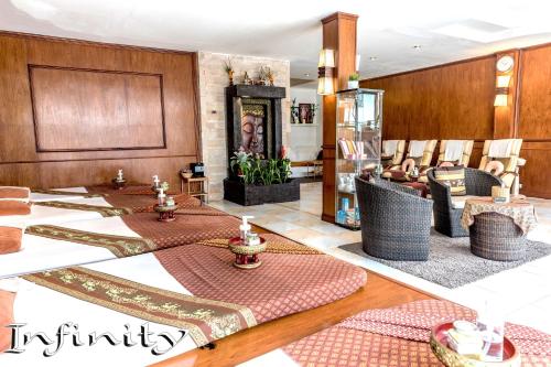 a lobby with tables and chairs in a room at Infinity Guesthouse in Ko Tao