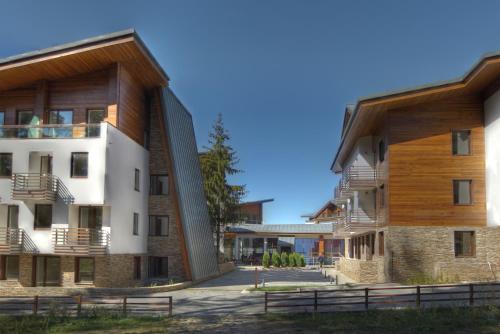an external view of two buildings with woodenadding at Euphoria Club Hotel in Borovets