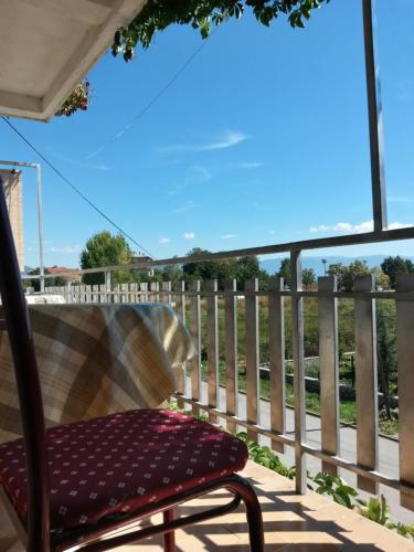 a chair sitting on a porch with a fence at Marko Apartments in Struga