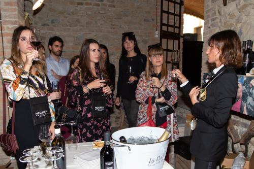 a group of people standing around a table with wine glasses at Agriturismo La Ratta in Vernasca