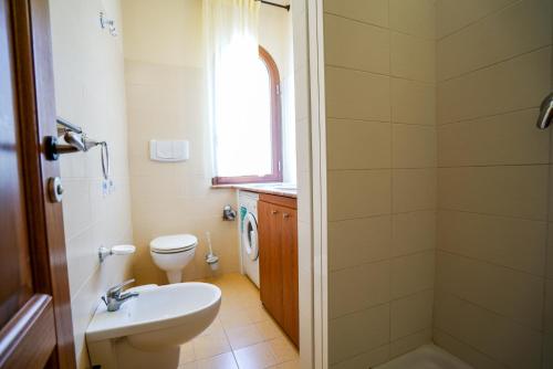 a bathroom with a toilet and a sink at Solemare Club Village in Capo Vaticano