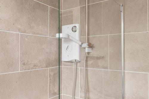 a shower in a bathroom with a glass door at Dalkeith Three Bed Two Bath Apartment in Dalkeith
