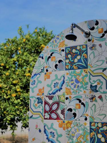 a patterned object with trees in the background at Villa Joyosa Apartments in Ischia Town