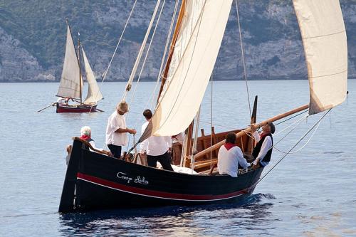 a group of people on a sail boat in the water at Apartments Popaj in Komiža
