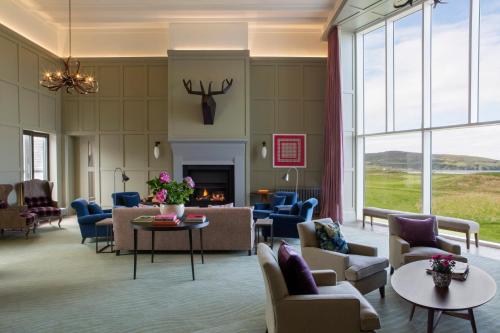 a living room with couches and chairs and a fireplace at Machrie Hotel & Golf Links in Port Ellen