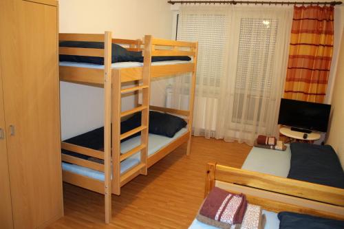 a room with two bunk beds and a desk at Ubytování Markéta in Perná
