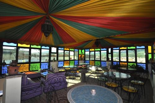 a large room with tables and colorful umbrellas at Riad Khouloud in Fez