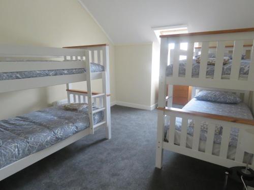 a room with two bunk beds in a room at Cunninghame House in Beith