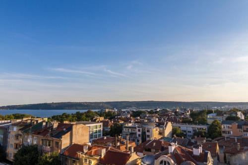 a cityscape of a city with buildings and a lake at Plaza Hotel in Varna City