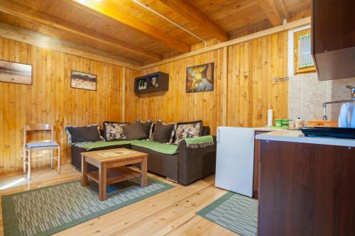 a living room with a couch and a table at Woodland ABC in Žabljak