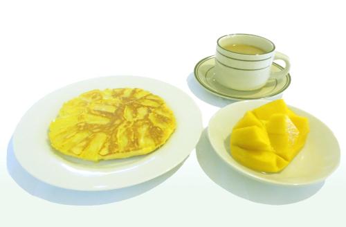 a plate with a pie and a cup of coffee at Sulu Plaza in Boracay