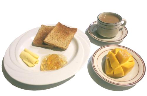 a plate of food with bread and a cup of coffee at Sulu Plaza in Boracay