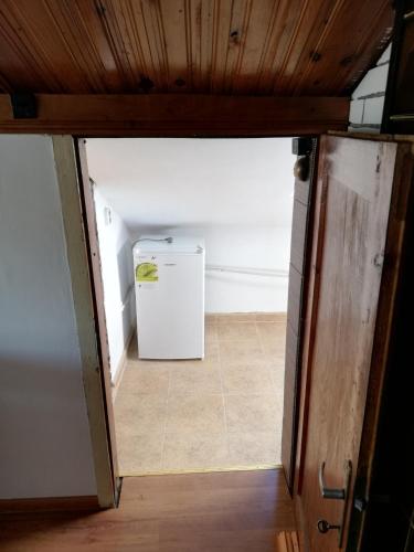 a room with a small refrigerator in a room at Guest Room Asparuh in Troyan