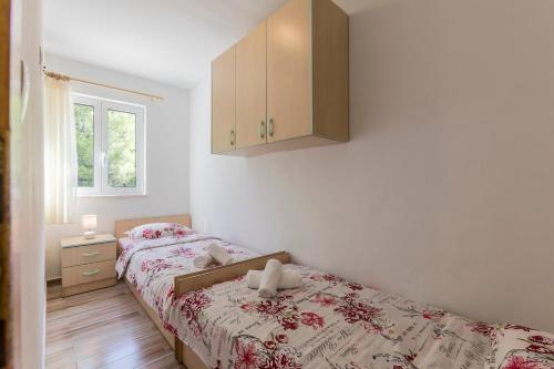 Postel nebo postele na pokoji v ubytování Apartmani Marinela
