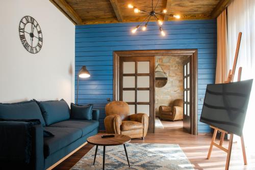 a living room with blue walls and a blue couch at KABAN BOUTIQUE HOTEL - 5Star Central Villa in Vatra Dornei in Vatra Dornei