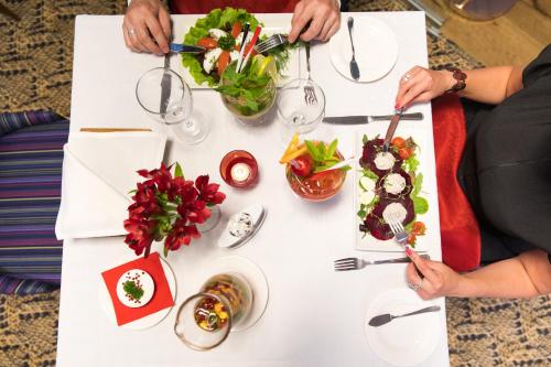 
a white table topped with plates of food at Kubija Hotel and NatureSpa in Võru
