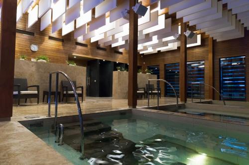 a hot tub in a hotel lobby with a chandelier at Kubija Hotel and NatureSpa in Võru