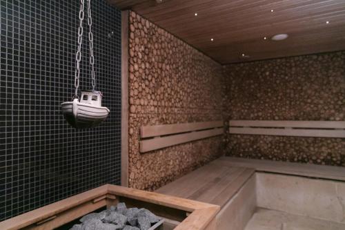 a bathroom with a bath tub and a swing at Kubija Hotel and NatureSpa in Võru