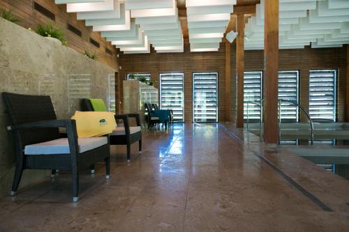 a large room with chairs and tables and windows at Kubija Hotel and NatureSpa in Võru