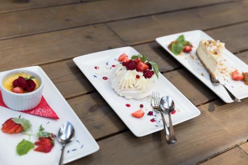 three plates of food on a table with desserts at Kubija Hotel and NatureSpa in Võru