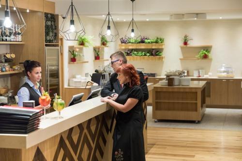 two women standing at a counter in a store at Kubija Hotel and NatureSpa in Võru