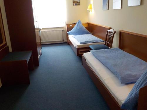 a hotel room with two beds and a window at Porsche Hotel in Wolfsburg