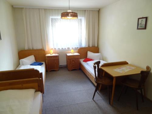a room with two beds and a table and a window at Haus Eberhard in Vent