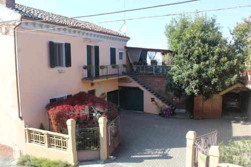 a white house with a staircase in a yard at La Terrazza sul Monferrato in Ozzano Monferrato