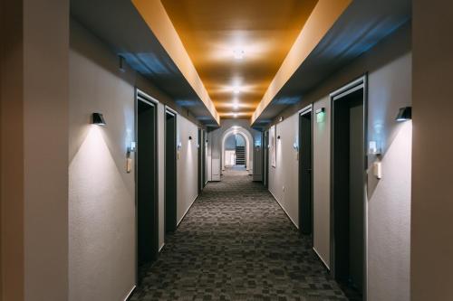 a hallway in a hospital with a hallwaygue at Romantique Veles Hotel in Veles