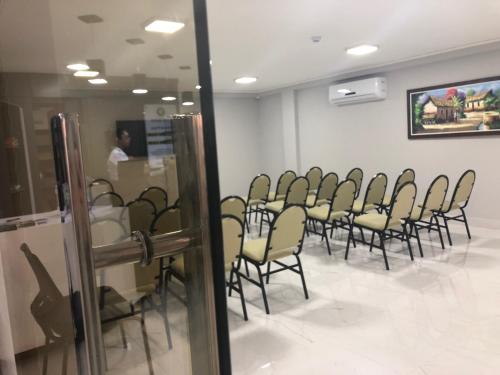 a room with a row of chairs in a room at Hotel Oásis de Patos in Patos