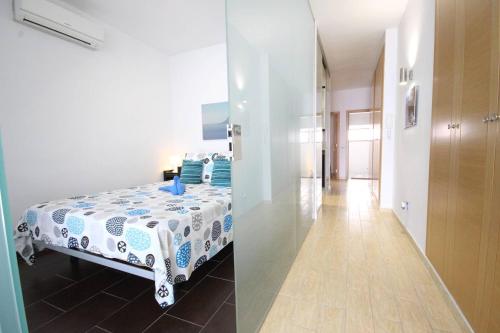 two images of a bedroom with a bed and a hallway at Luxury Apartment Cristianos Beachfront in Los Cristianos
