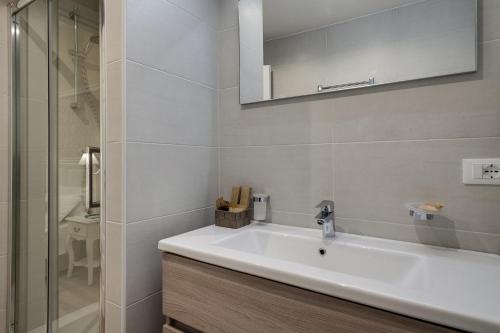 a bathroom with a white sink and a shower at Charme & Chic Luxury in Rome