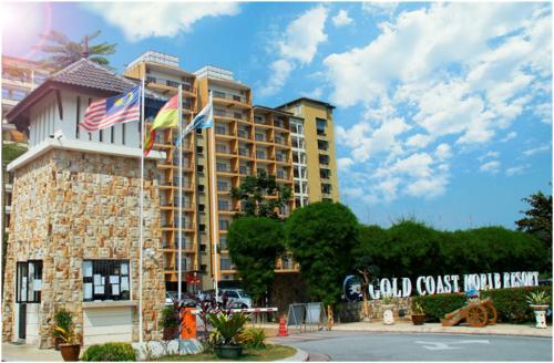 a tall building with flags in front of it at ZamLan Gold Coast Morib Intl Resort - 3 Rooms Apartment in Banting