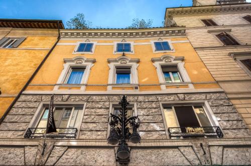 a tall building with windows and a street light at Charme & Chic Luxury in Rome